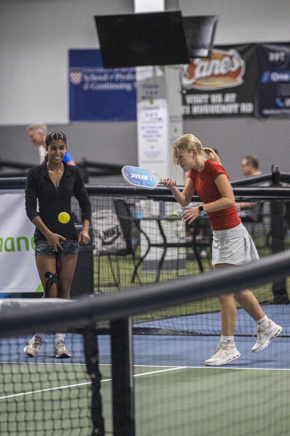 Players rallying on the indoor courts