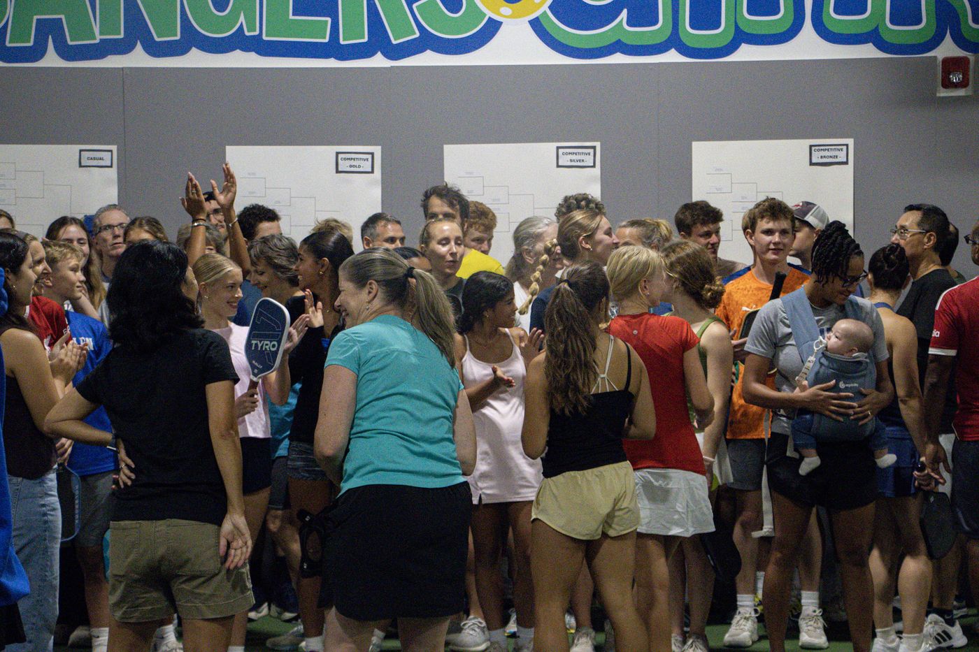 Crowd of players gathered together between rounds
