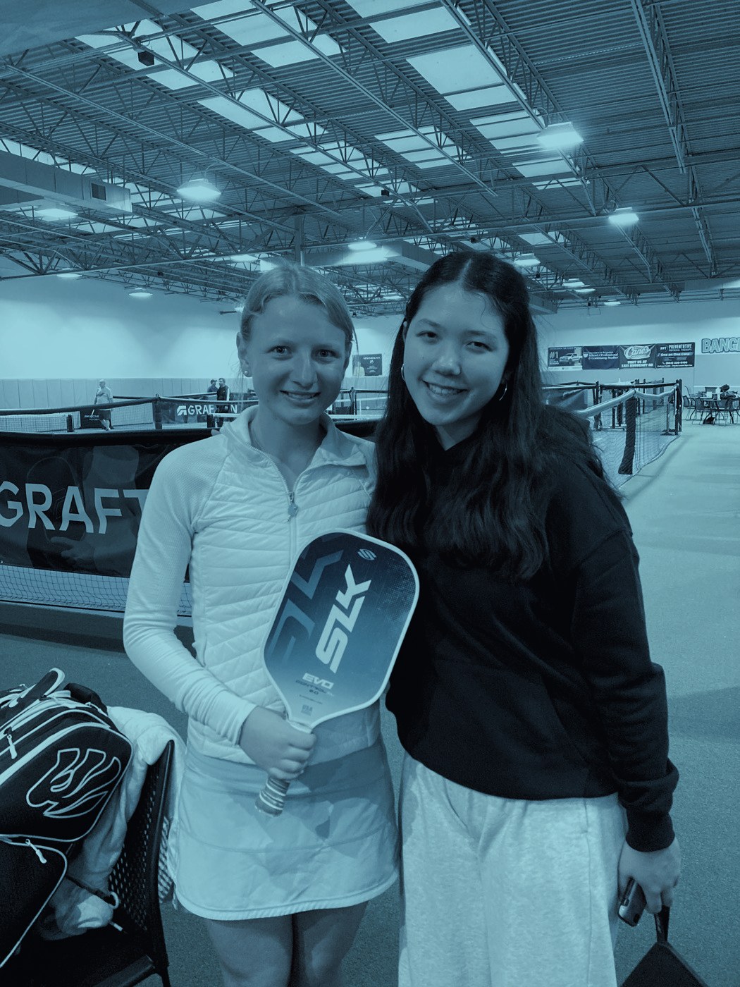 Two players with their paddles between matches