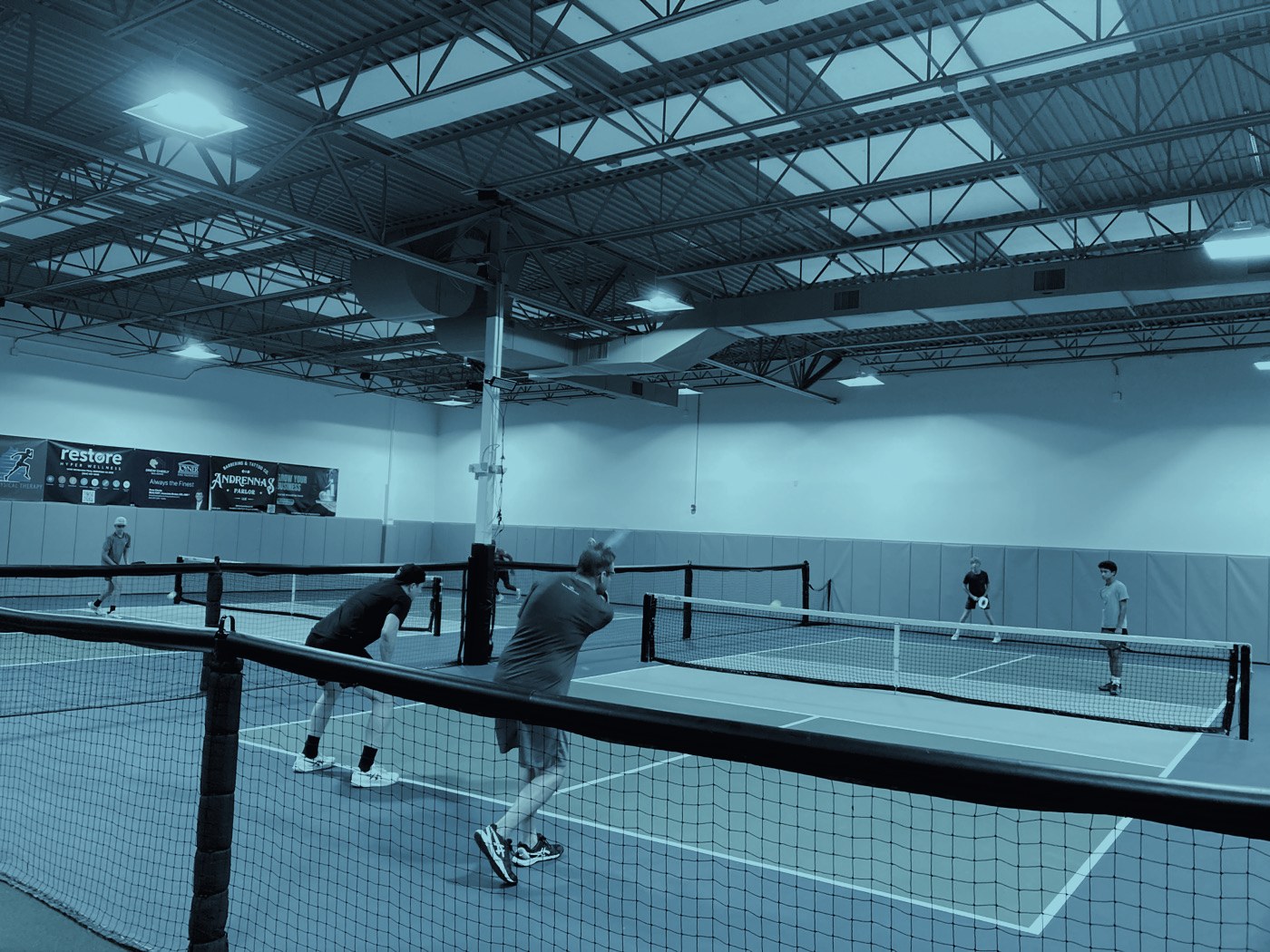 Players competing across the indoor courts