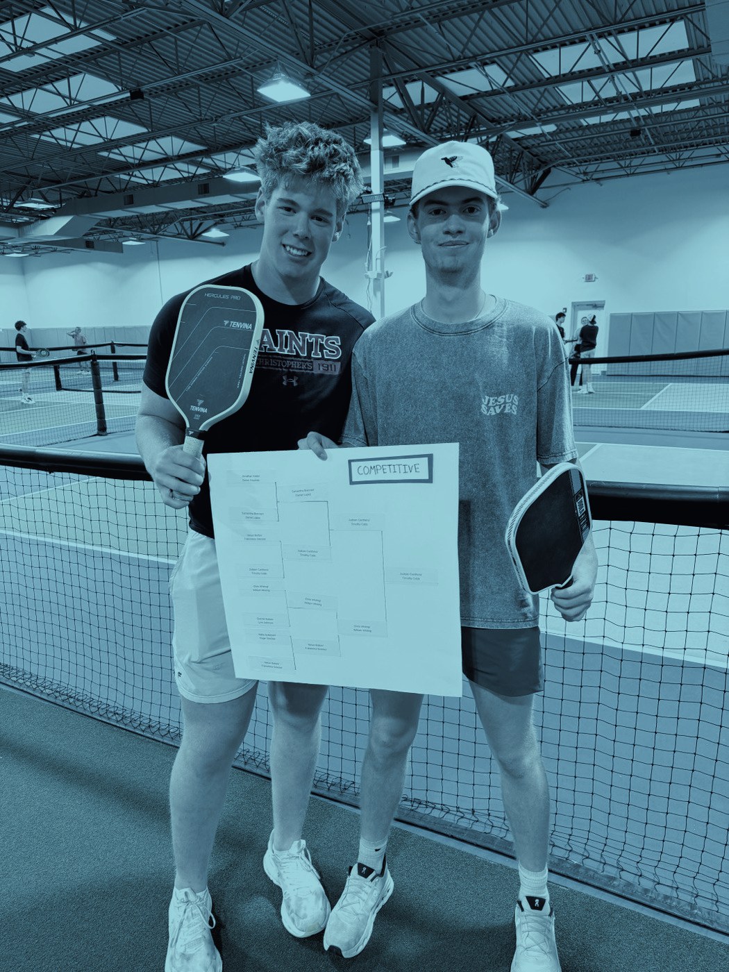 Two players holding the tournament bracket sheet