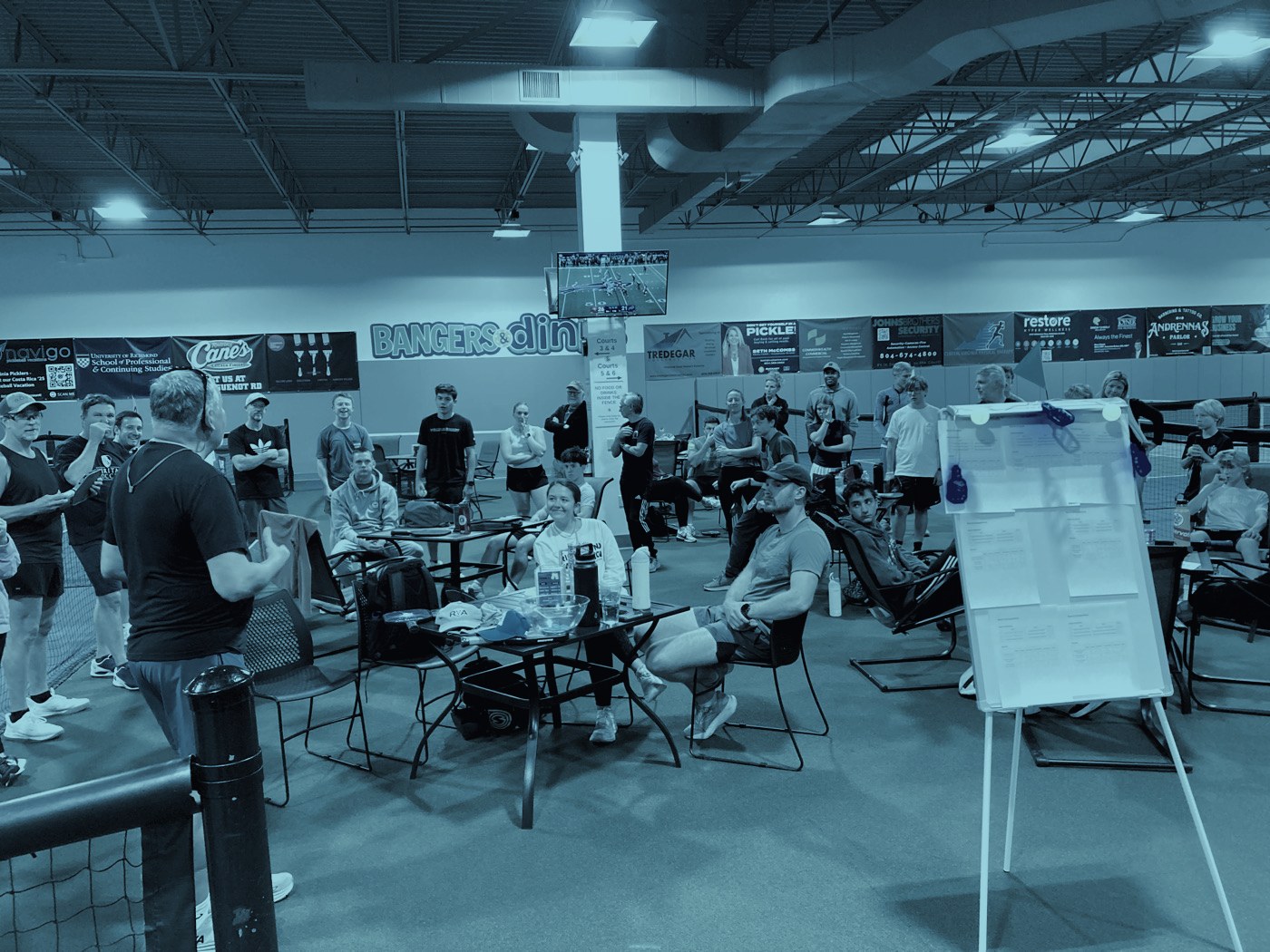 Attendees gathered at tables between rounds